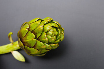 Purple artichoke on dark background.