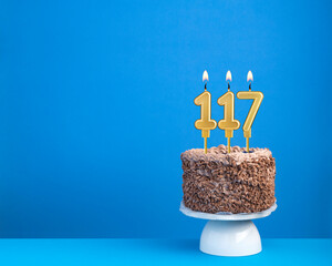 Birthday cake with candle 117 - Invitation card on blue background