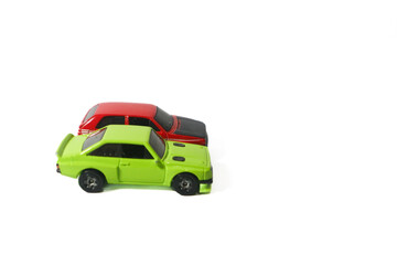 green and red toy cars on isolated white background