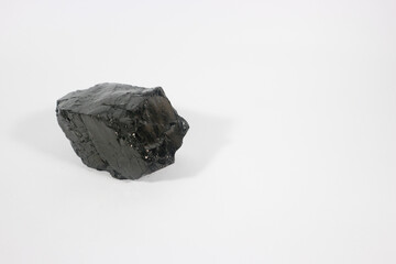 coal on a white background. Isolated on white. object is on the right, copy space. Coal can be a fuel that is cheaper than others