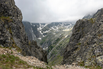 The cold valley of the five Spiš Lakes with a mountain hut, view from Lomnicke saddle High Tatras Slovakia