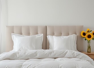 White bed with beige headboard and sunflowers on nightstand in a minimalistic bedroom interior