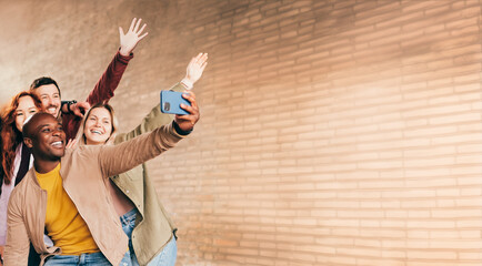 Group of happy friends taking selfie portrait on the city street. Multiracial young people having fun together outside - Friendship concept - Focus on the black man.