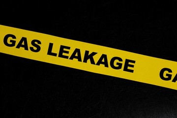Gas leak or leakage caution danger and warning concept. Yellow barricade tape with word in dark...
