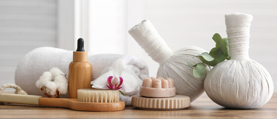 Composition with spa accessories and flowers on wooden table
