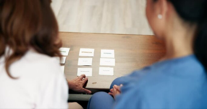 Nurse, senior woman and exercise in Alzheimers with paper for memory, problem solving and support. Nursing home, caregiver and patient with word activity for cognitive, brain training and recognition