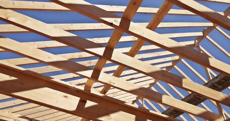 Wooden roof beam is constructed from frames of trusses rafters