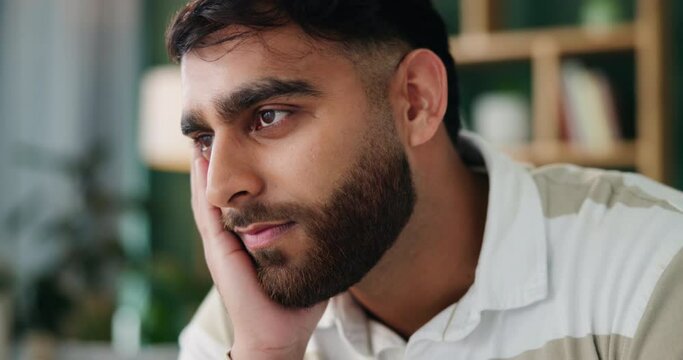 Thinking, man and bored or tired in home with nostalgia, depression and grief from broken heart. Indian person, lonely guy and sad thoughts with remember memory, mental health crisis and fatigue