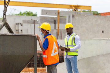 Engineer and foreman worker checking project at building site, Engineer and builders in hardhats...