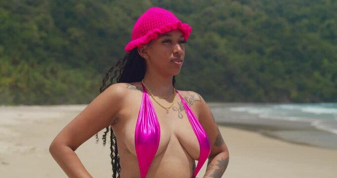 In Trinidad, a girl in a thong bikini enjoys a beautiful day on a Caribbean beach.