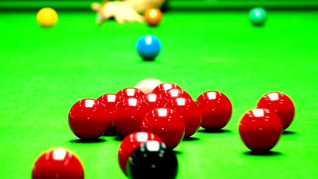 Man is starting snooker game by hit a group of red balls by white ball, in door  Chiangmai  Thailand.