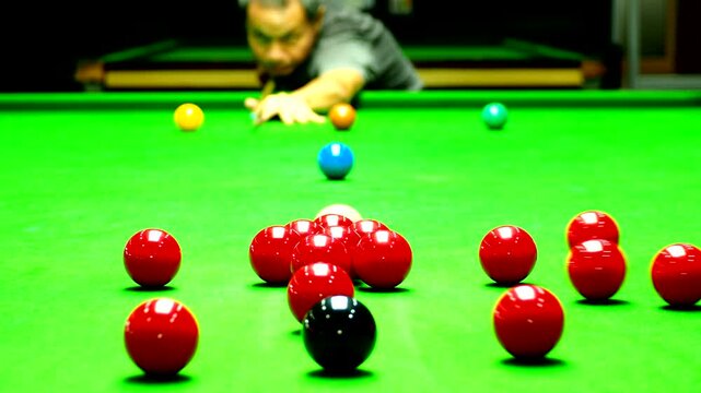 Man is starting snooker game by hit a group of red balls by white ball, in door  Chiangmai  Thailand.