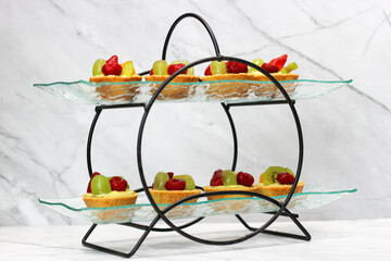 several fruit pies lined up on a tray. Mini cake.