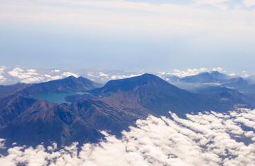 The beauty of Mount Rinjani Peak surrounded by clouds with Segara Anak Lake seen from a height. Mount Rinjani is an active volcano in East Lombok, West Nusa Tenggara, Indonesia which is also a favorit