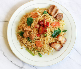 top of view of bihun goreng on white plate. isolated on white.