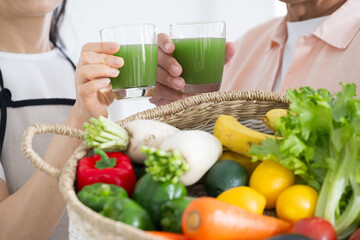 No close-up face of a senior who enjoys healthy foods such as green juice and other green and yellow vegetables that are good for her body.