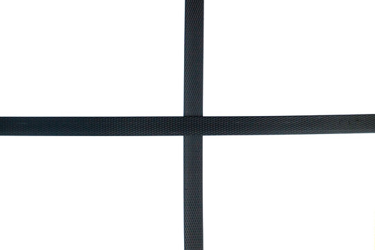 Black nylon cord strap for industrial use isolated on white background, close up plastic poly strap for cargo box. Composite cord strapping belt for securing a transportation.