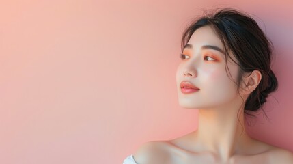 Fototapeta premium Portrait of a beautiful young Asian woman with a clean and fresh look on a pink background. Concept of skincare, cosmetics, beauty and wellness.