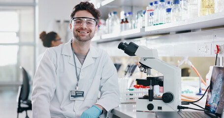 Portrait, scientist and happy man on microscope in lab for chemistry research, test or innovation....