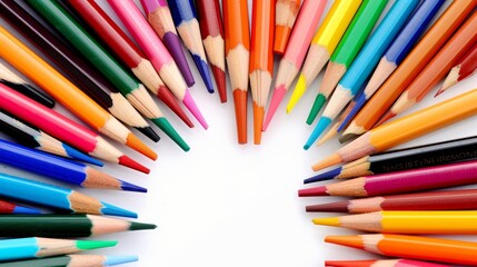 Fototapeta premium A vibrant collection of colored pencils in a variety of hues arranged in a fan shape, surrounded by sketching tools like sharpeners and erasers, artistic setting