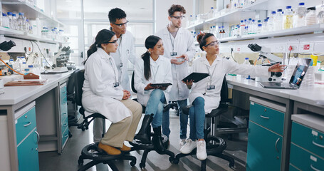 Laptop, science and group of people in laboratory for learning, cancer cure or medical development....