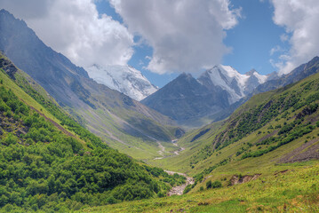 Mountain valley and high mountains on the horizon.