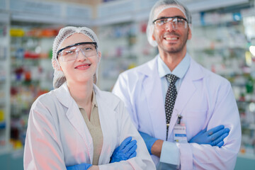 Male and female doctor scientists stand with confidence. With specialized skills in conducting scientific experiments in a laboratory full of test substances and chemical products for making medicines