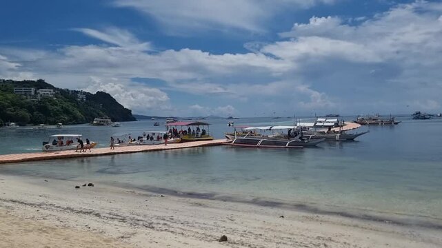Handheld shot of people disembarking from a boat to Boracay a small island in the central Philippines.