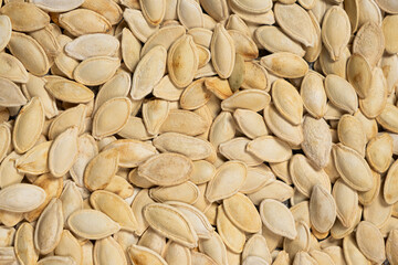 Close-up of unpeeled pumpkin seeds from above.