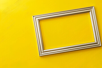 Fototapeta premium Minimalist silver frame on yellow background, top view, flat lay, high resolution, copy space concept