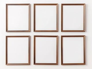 Fototapeta premium Six brown picture frames on white wall, ready for artwork displa