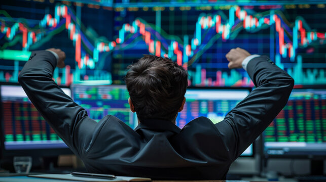 business man congratulations stock trader sitting at a desk in front of computer monitors