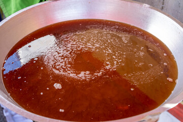 cooking oil in a large frying pan for frying food such as crispy chicken and other street foods. The concept of cholesterol and unhealthy food