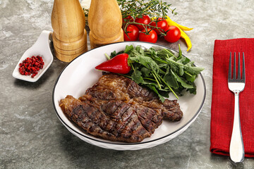 Grilled chuck roll steak with arugula