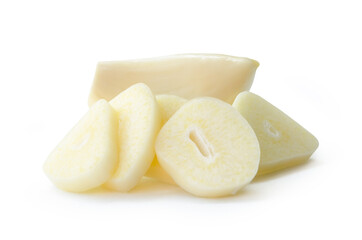 Front view of peeled white garlic cloves with slices or pieces in stack isolated on white...