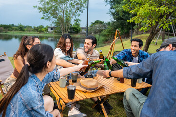 Group of diverse friend having outdoors camping party together in tent. 