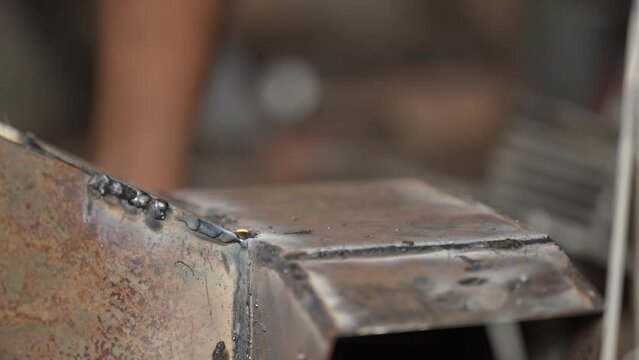 the process of welding steel plates by a blacksmith
