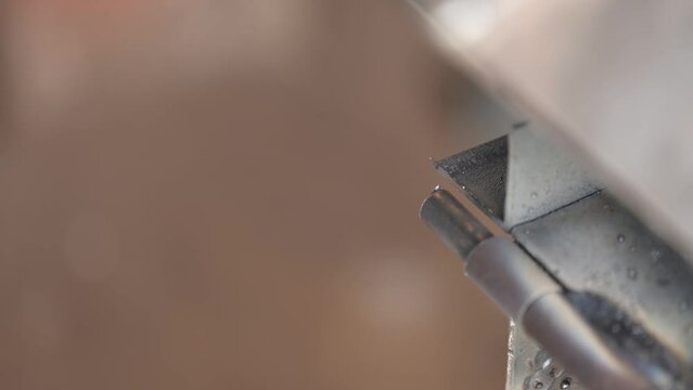 close-up view of the iron plate grinding process