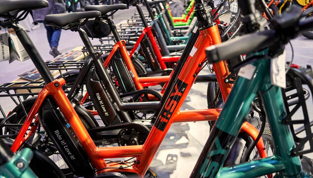 Isy e-bikes in a row, small powerful red full-featured electric bicycles