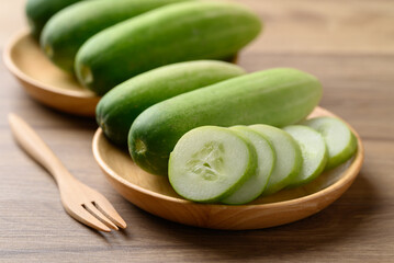 Sliced cucumber on wooden plate, Organic vegetable, Food ingredient