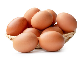 Front view of fresh brown chicken eggs in stack in wicker basket isolated on white background with clipping path