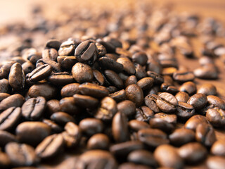 Dark roasted coffee beans, shallow focus - high contrast, warm light