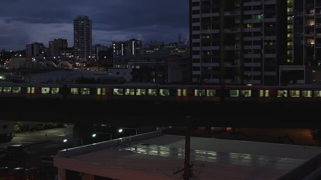 Under canopy of midnight velvet, train travels through quiet darkness