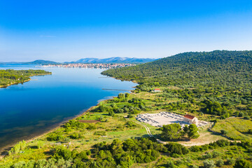 Ivinj archeological site with Saint Martin Church and town of Pirovac in background, Croatia