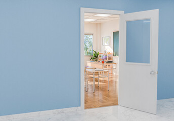 Open Doorway to Bright Classroom with Desks and Chalkboard