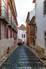 The historic Old Town of Lisbon features classic architecture and a signature red tram, capturing the essence of Portugals capital through its stunning views and charming ambiance