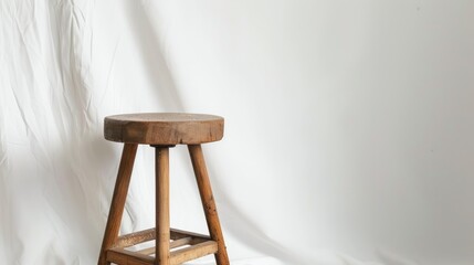 Vintage wooden stool on white backdrop with copy space