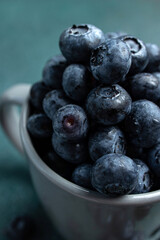 Blueberries in a cup on a dark background. Top view.