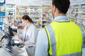 The pharmacist provides medicine to the engineers who come to buy medicine in the pharmacy