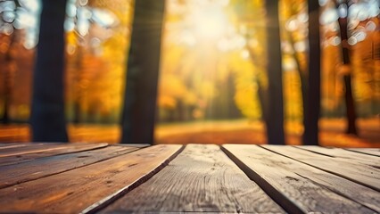 Fototapeta premium autumn banner with empty wood table top, blurred trees, orange leaves. horizontal background with copy space